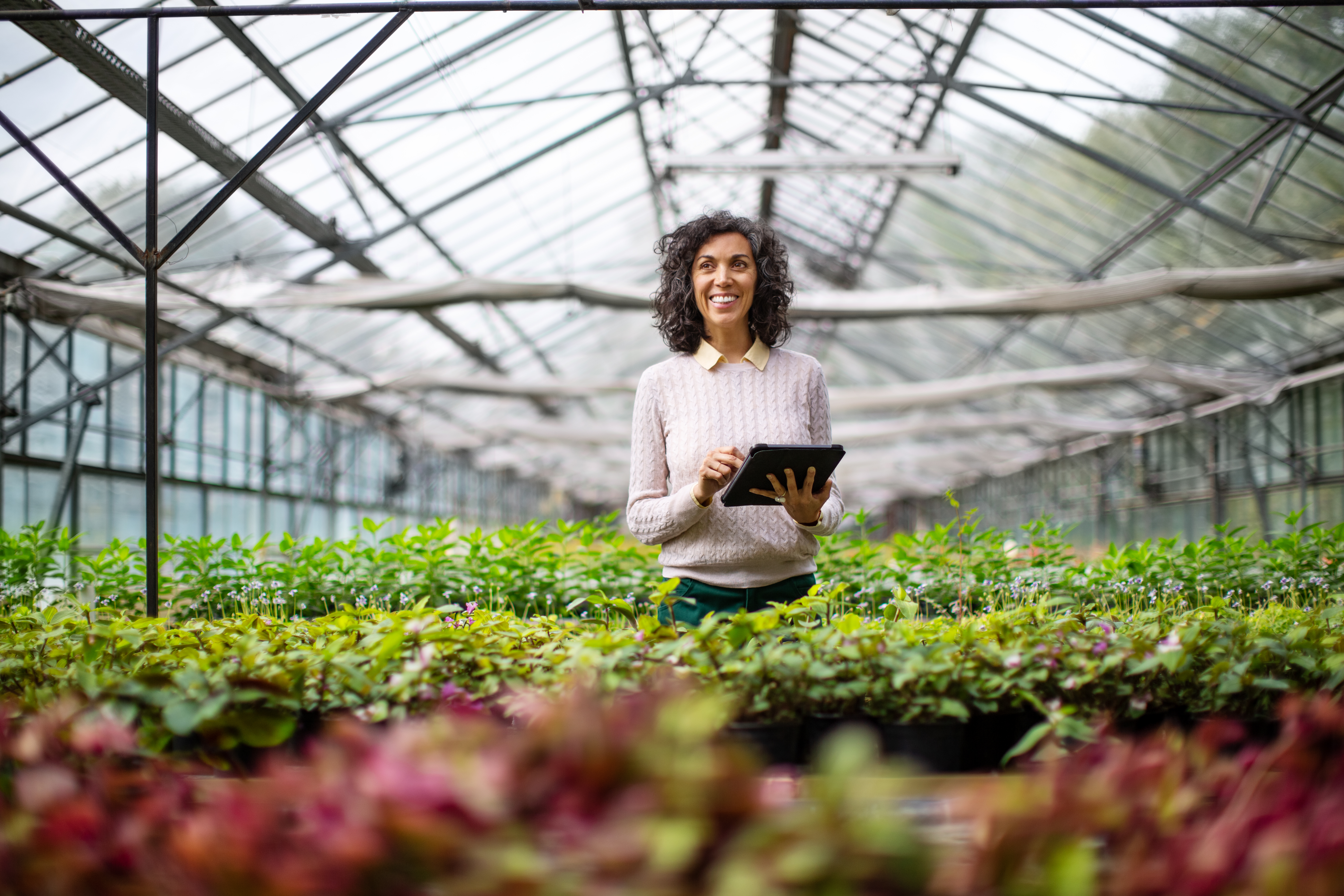 smiling woman holding a tablet